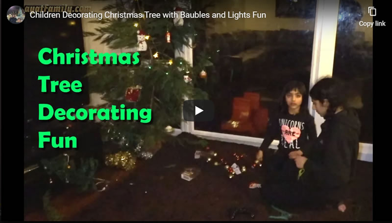 Children Decorating Christmas Tree with Baubles and Lights Fun